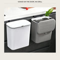 Hanging trash bin on a dark kitchen cabinet door, ivory and grey side by side