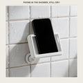 Waterproof phone box on a shower wall with a phone inside it