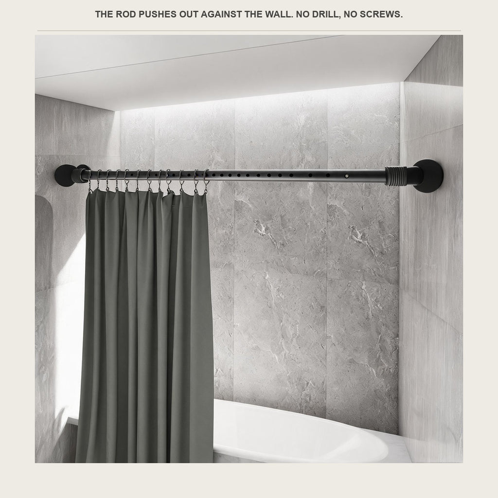Matte black tension rod pressed between two tiled bathroom walls with a grey shower curtain