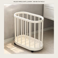 Cream slatted rolling storage bin on a bathroom tile floor with light falling across it