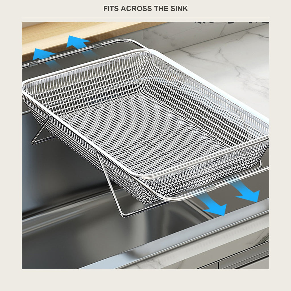 Stainless over-sink rinse basket spanning a kitchen sink with arms on the rim