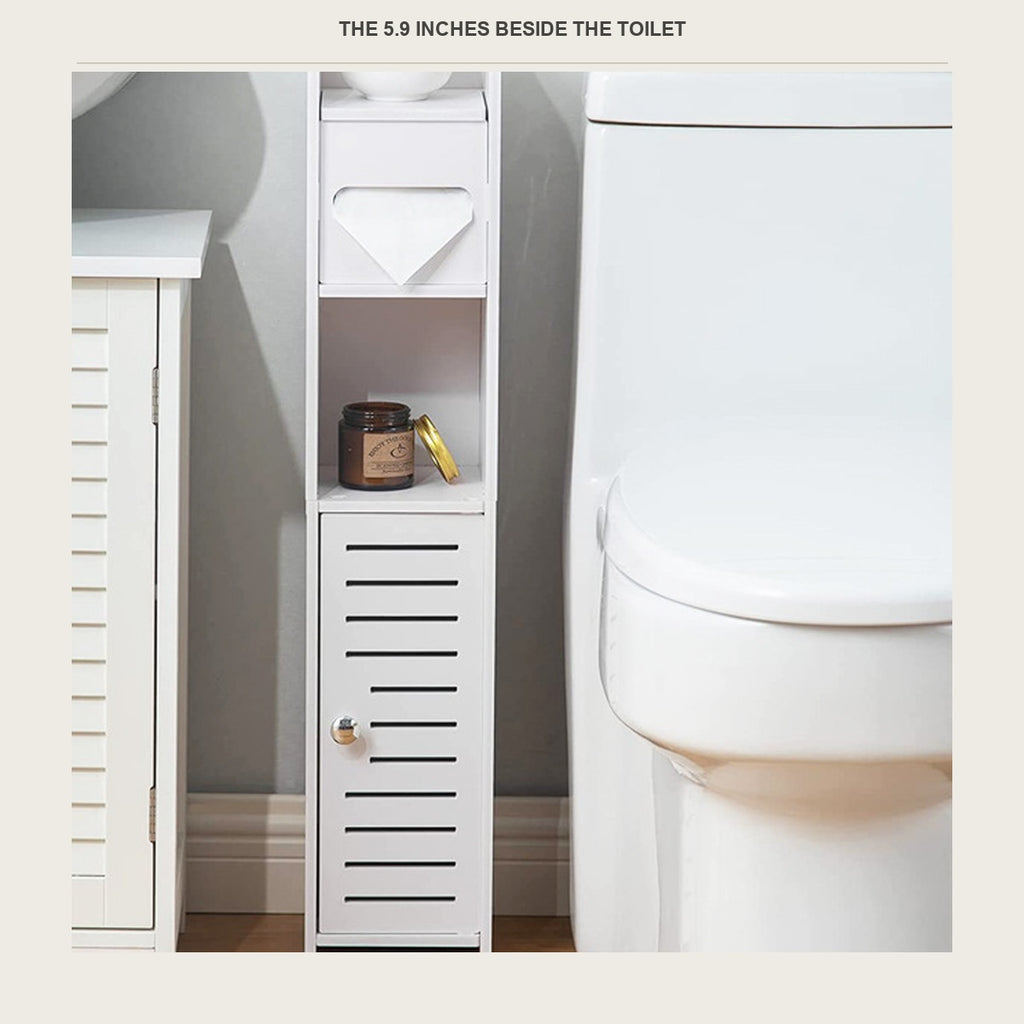 Narrow white floor cabinet standing in the gap between a toilet and a vanity