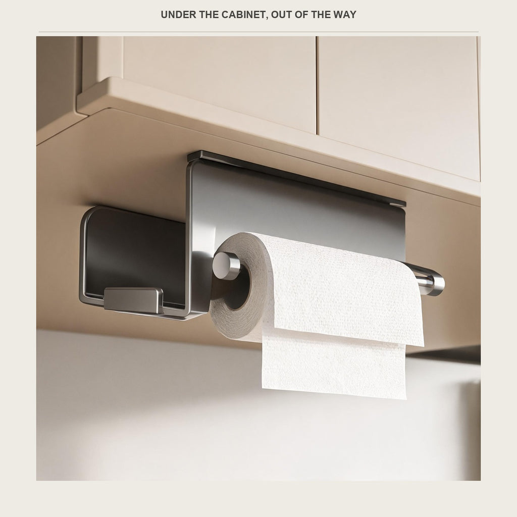 Under-cabinet paper holder mounted below a pale kitchen wall unit, holding a roll of kitchen paper