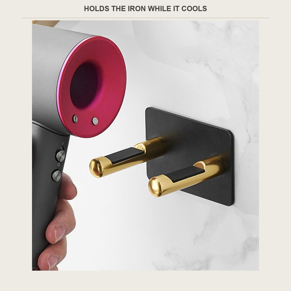 Hair dryer next to a wall-mounted hair tool holder in a bathroom