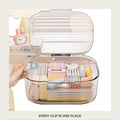 Clear hair accessory storage box with the lid flipped open, hair clips and ties inside