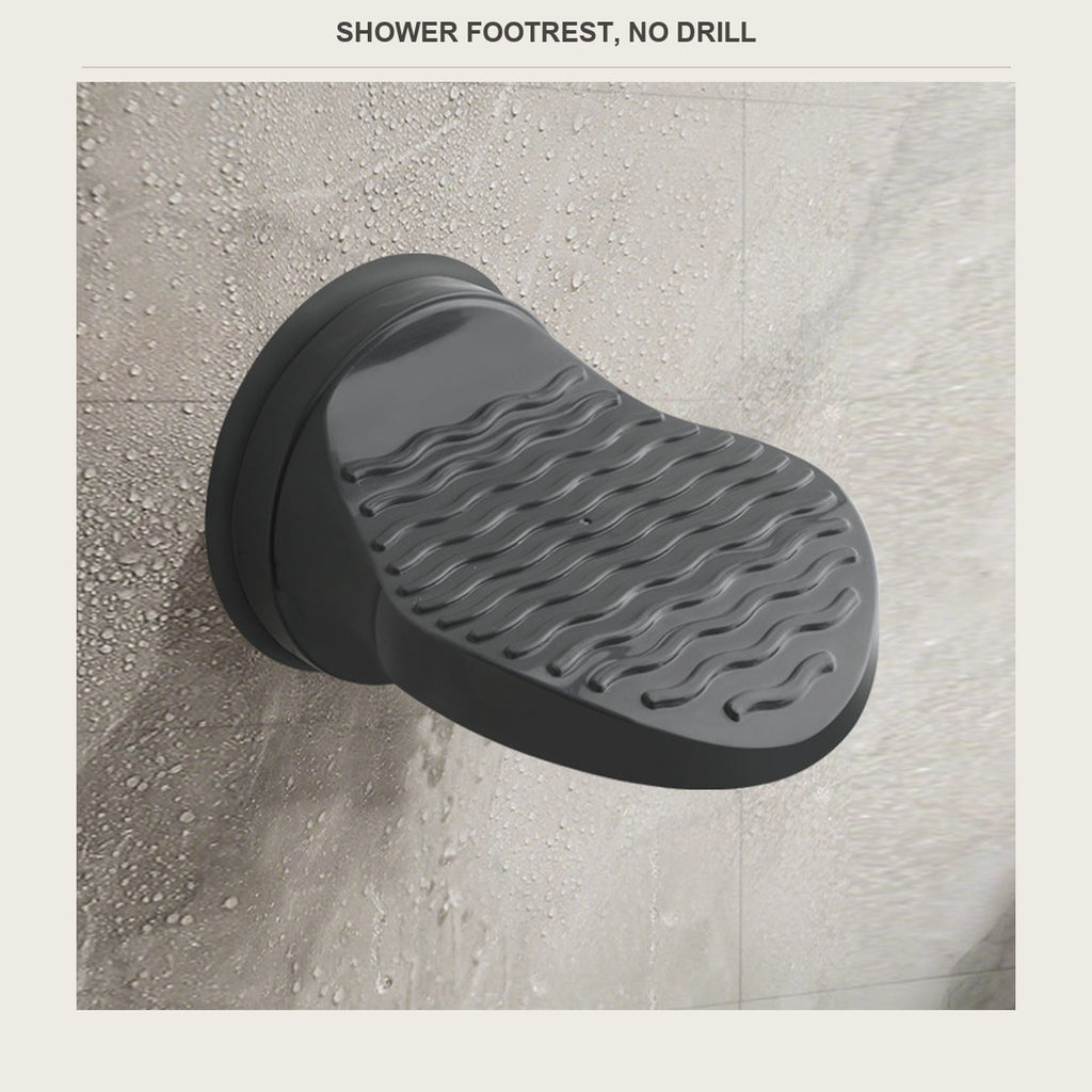Black suction shower foot rest mounted on a tiled shower wall