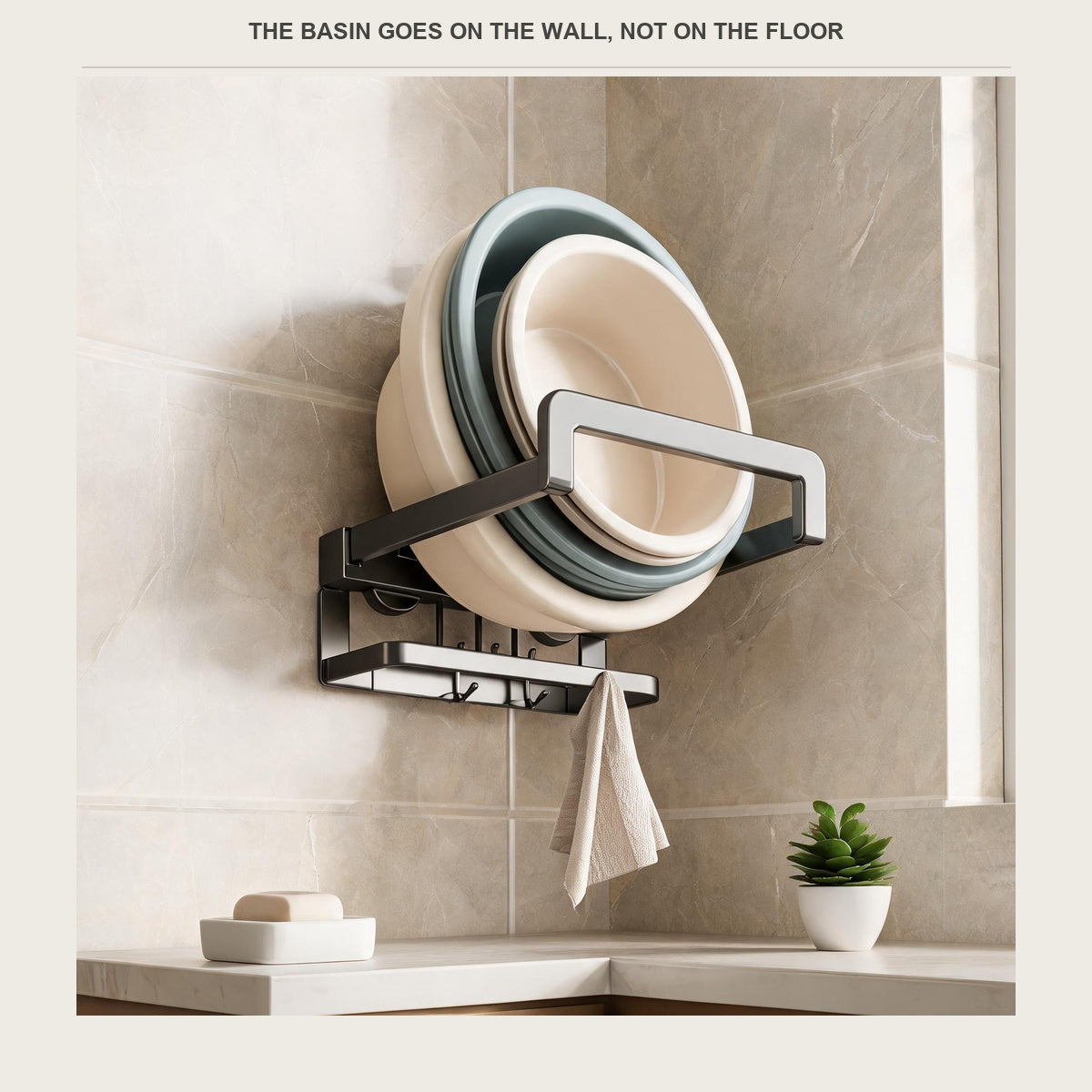 Foldable aluminium wall rack holding two basins on a tiled bathroom wall, with a towel on the hooks below