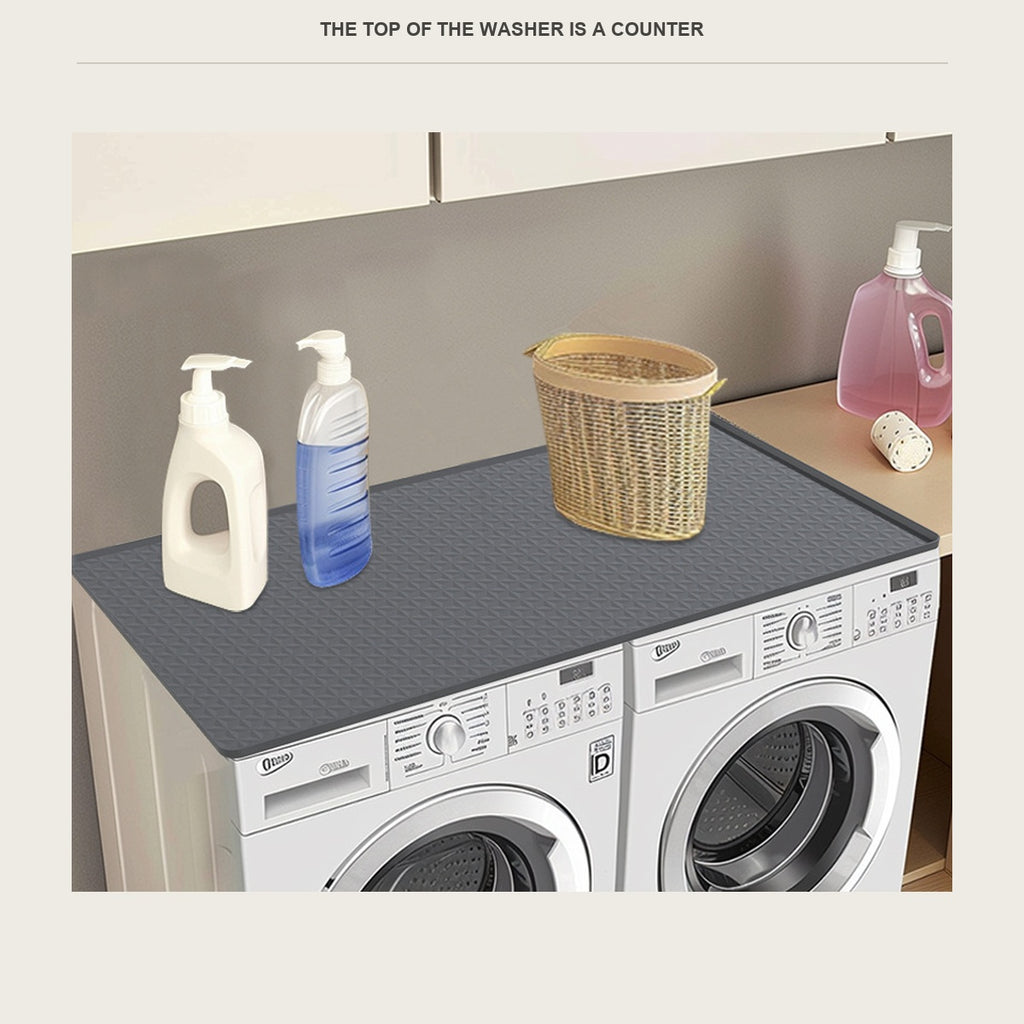 Non slip mat laid across the top of a washer and dryer side by side