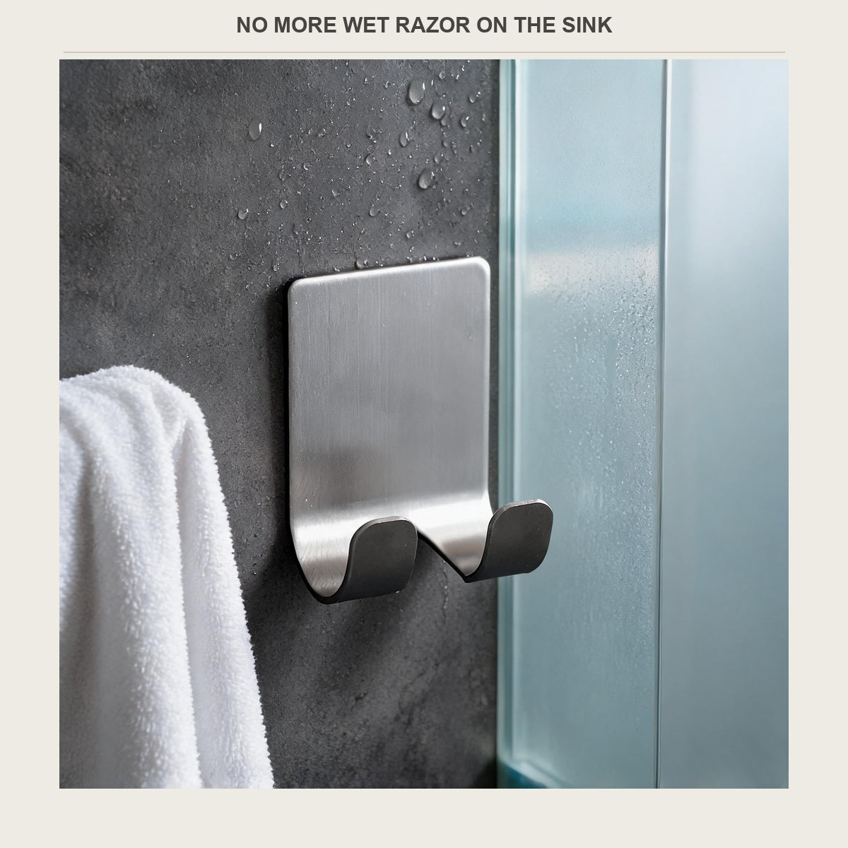 Stainless steel razor holder stuck on a bathroom wall with a razor hanging from it