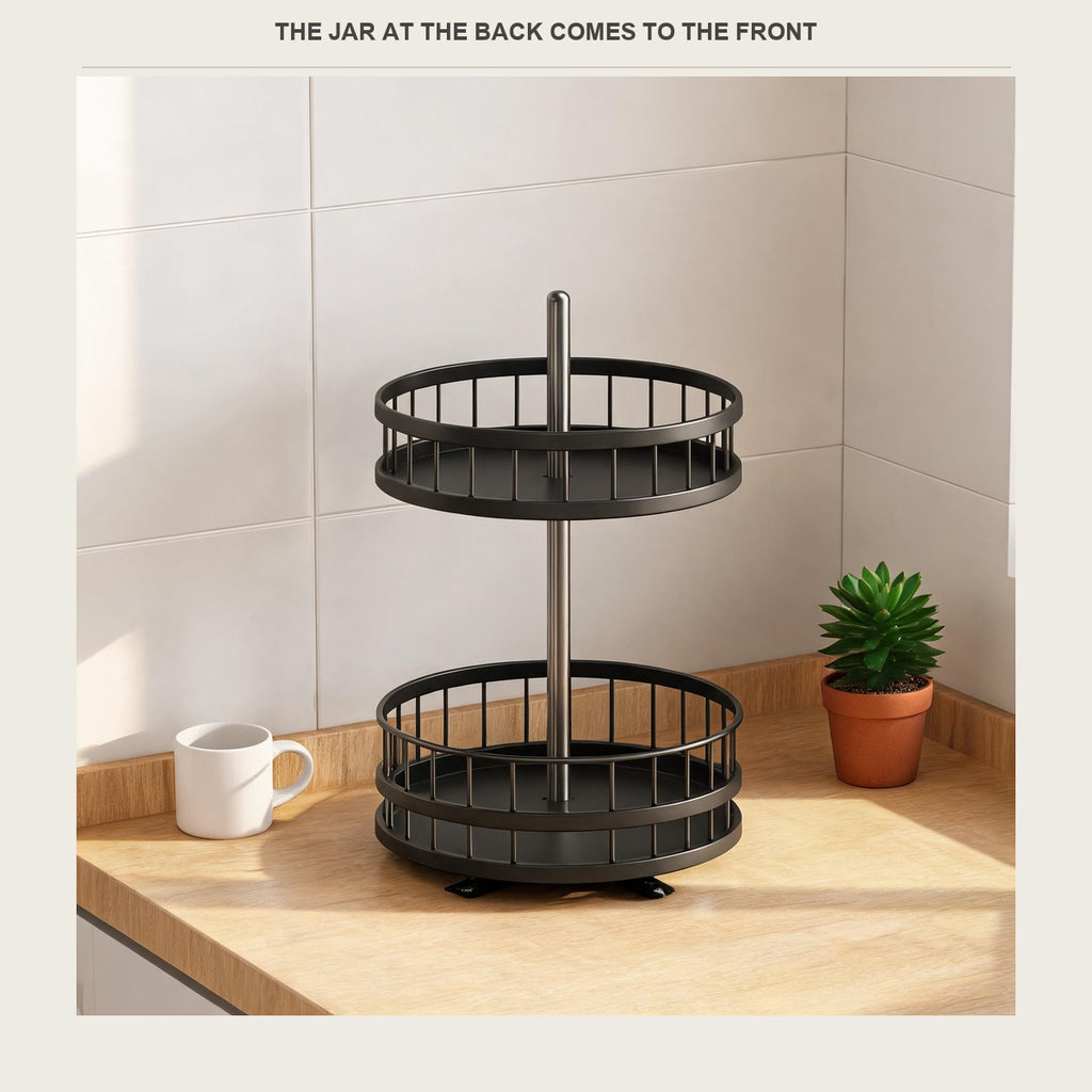 Matte black rotating spice rack standing empty on a light wood kitchen counter beside a white tile wall