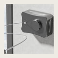 Grey retractable clothesline housing on a bathroom wall with the wire pulled out