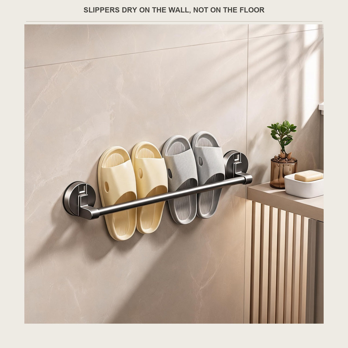 Suction shower slipper rack in gunmetal grey holding two pairs of slippers on a tiled bathroom wall