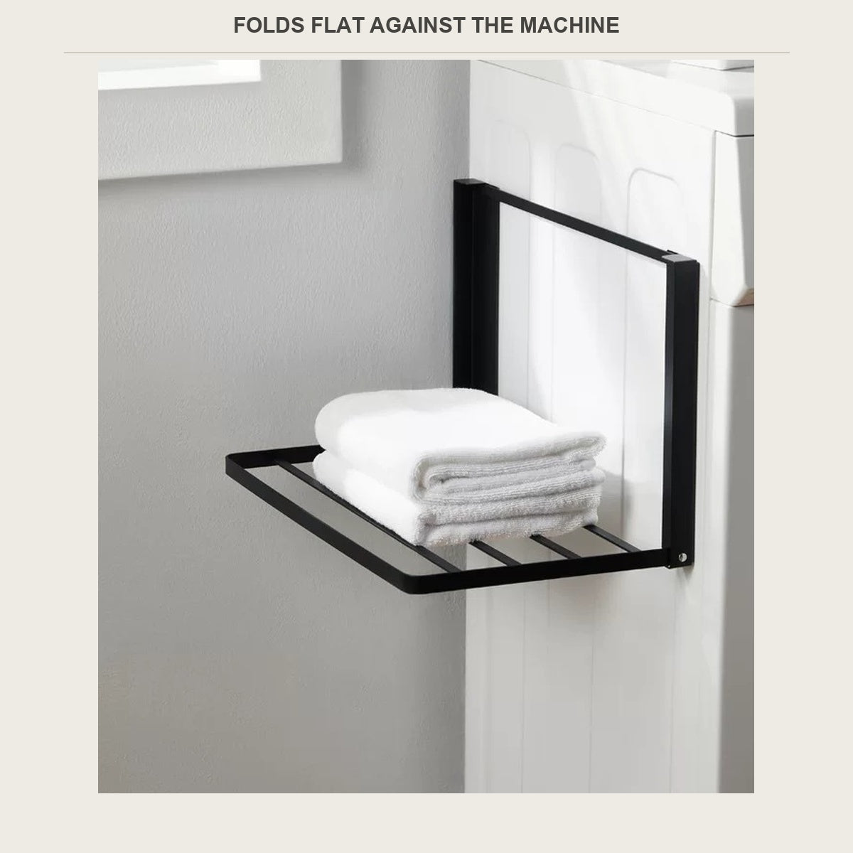 Magnetic folding shelf holding folded towels on the side of a washer