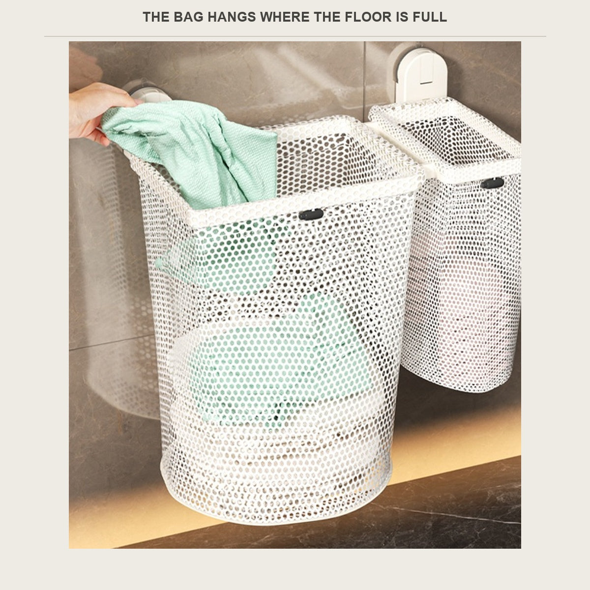 Hand dropping a towel into a wall-mounted mesh laundry hamper