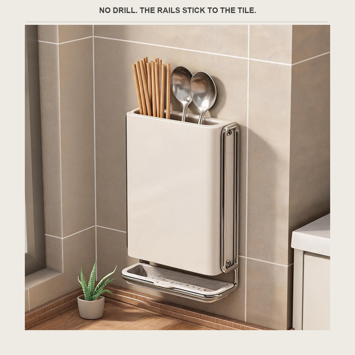 The utensil holder mounted on a grey tiled kitchen wall with chopsticks and spoons inside