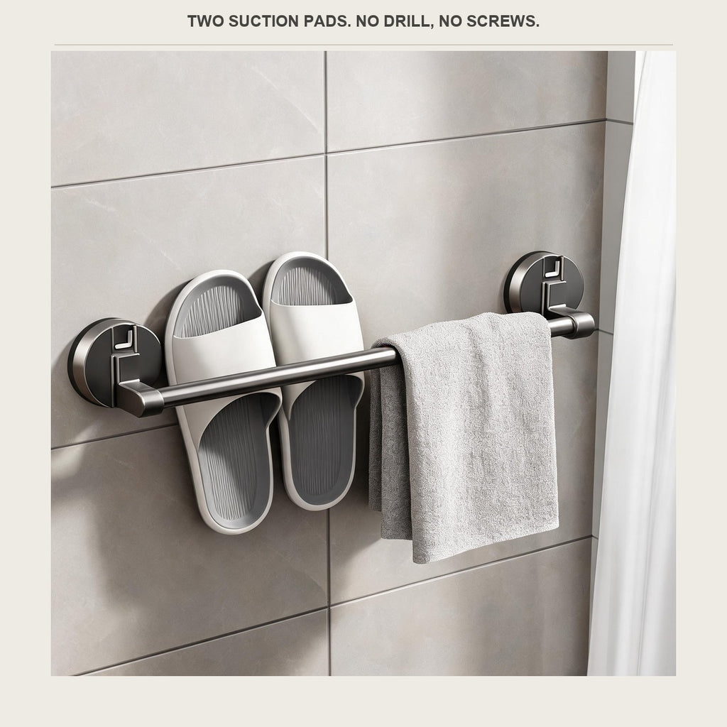 The slipper rack on a shower wall with one pair of slippers and a folded towel over the bar