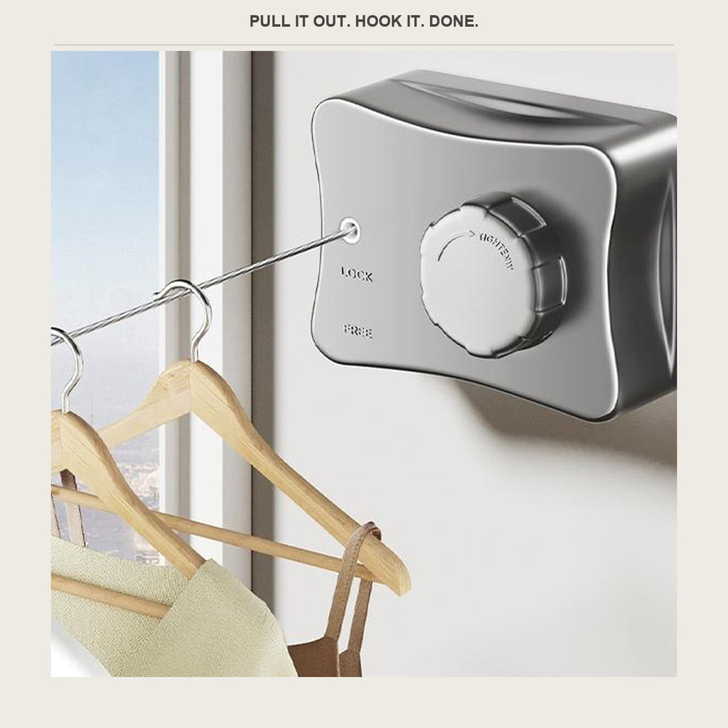 Retractable clothesline wire pulled across a window with wooden hangers on it