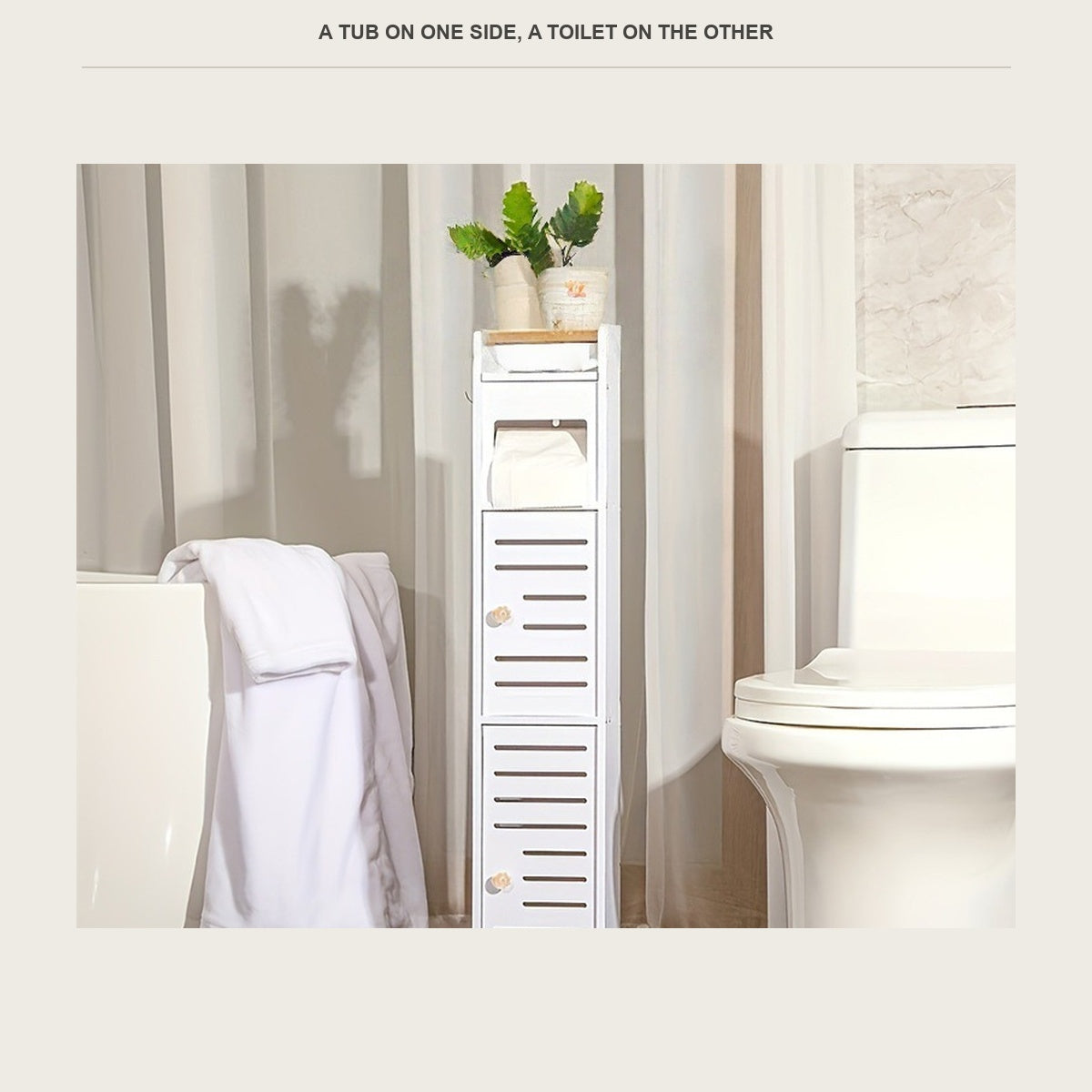 The narrow floor cabinet between a towel covered tub and a toilet