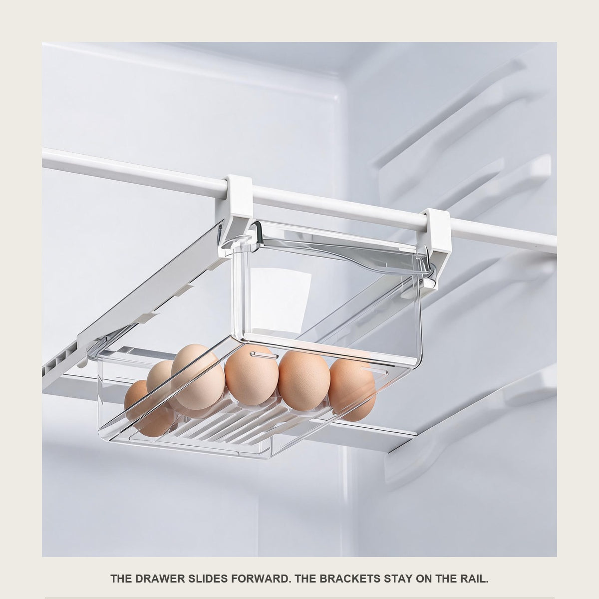 Close-up of the clear under-shelf drawer pulled forward along the white rail