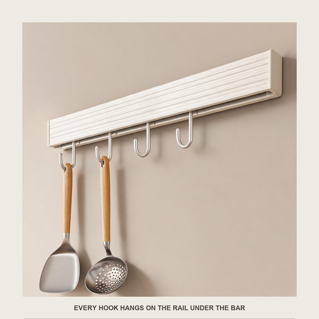 Close-up of slim champagne hooks hanging from the rail under the white bar