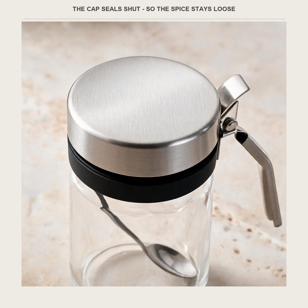 Close-up of the brushed stainless cap and the press lever that opens it