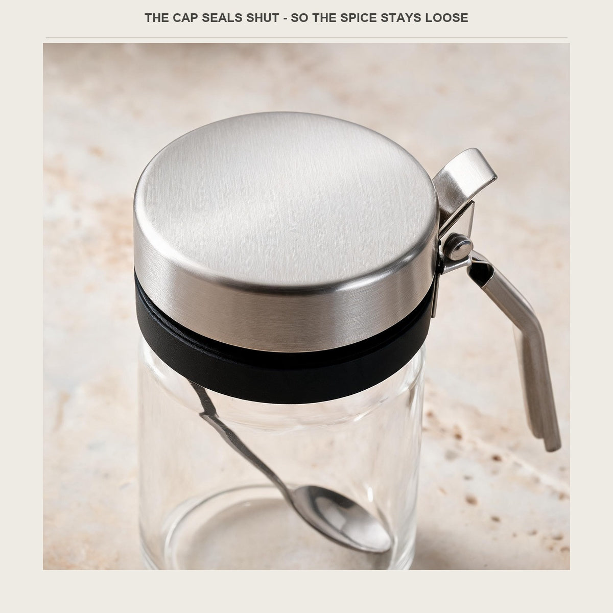 Close-up of the brushed stainless cap and the press lever that opens it