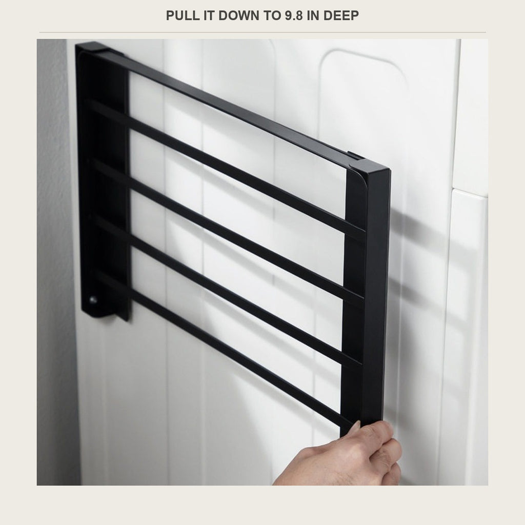 Pulling the hinged shelf down from its flat position against the machine
