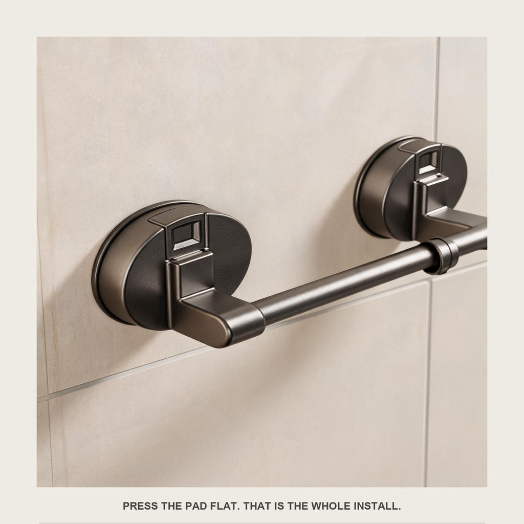 Close-up of the round suction pad pressed flat on tile with the locking latch on its face