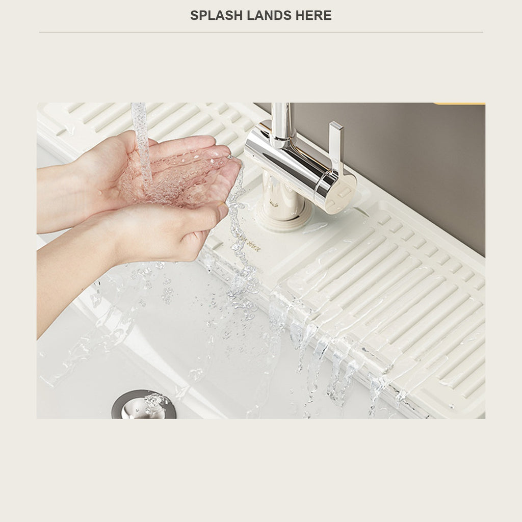 Water splashing onto the faucet mat while hands are washed under the tap