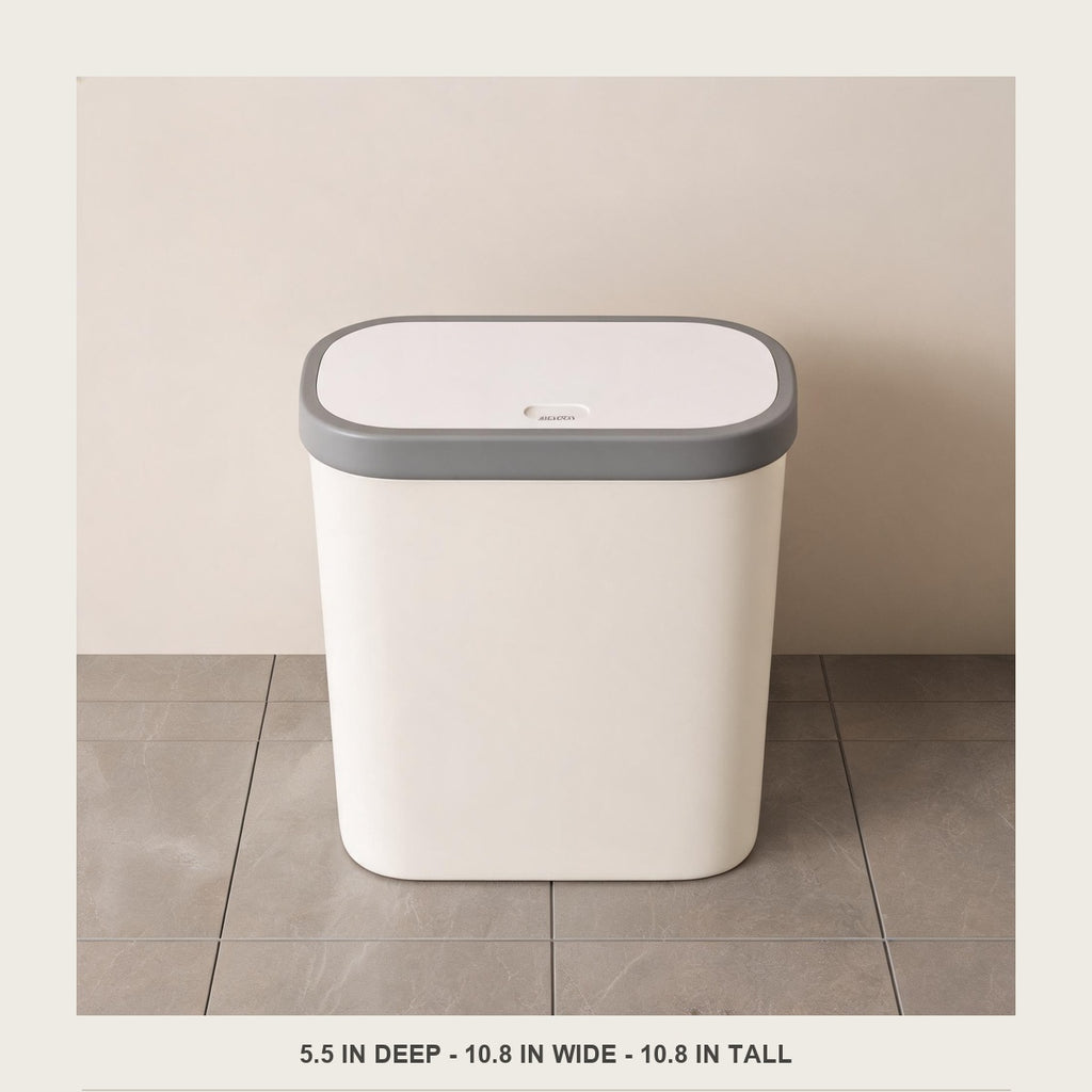 Front view of the empty slim bin on a tiled floor showing its 5.5 in depth footprint