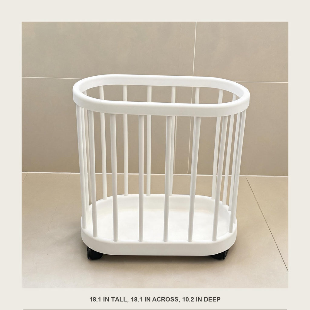 Front view of the empty rolling slatted storage bin against a plain tiled wall