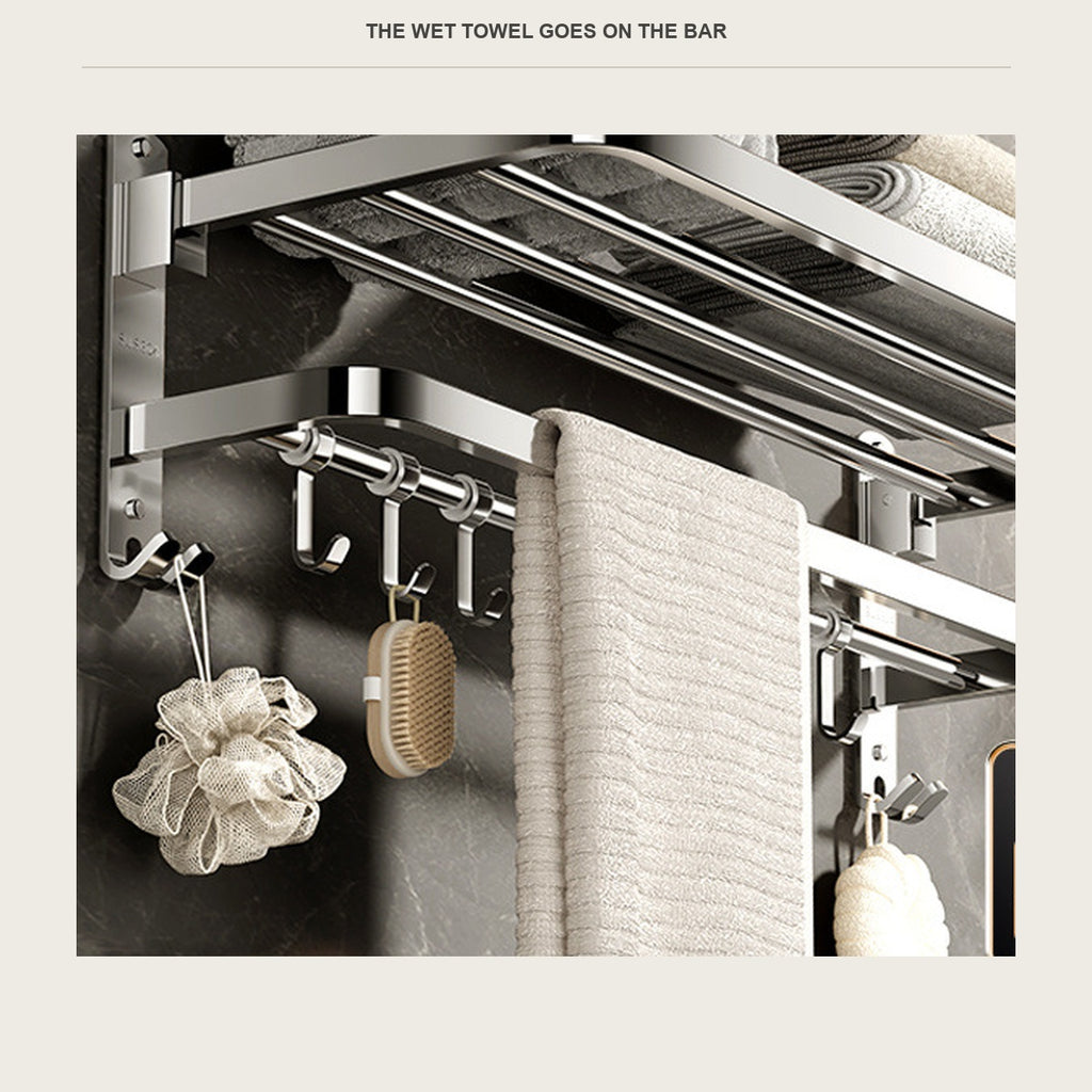Wet towel hanging on the bar below the folded towels on the shelf