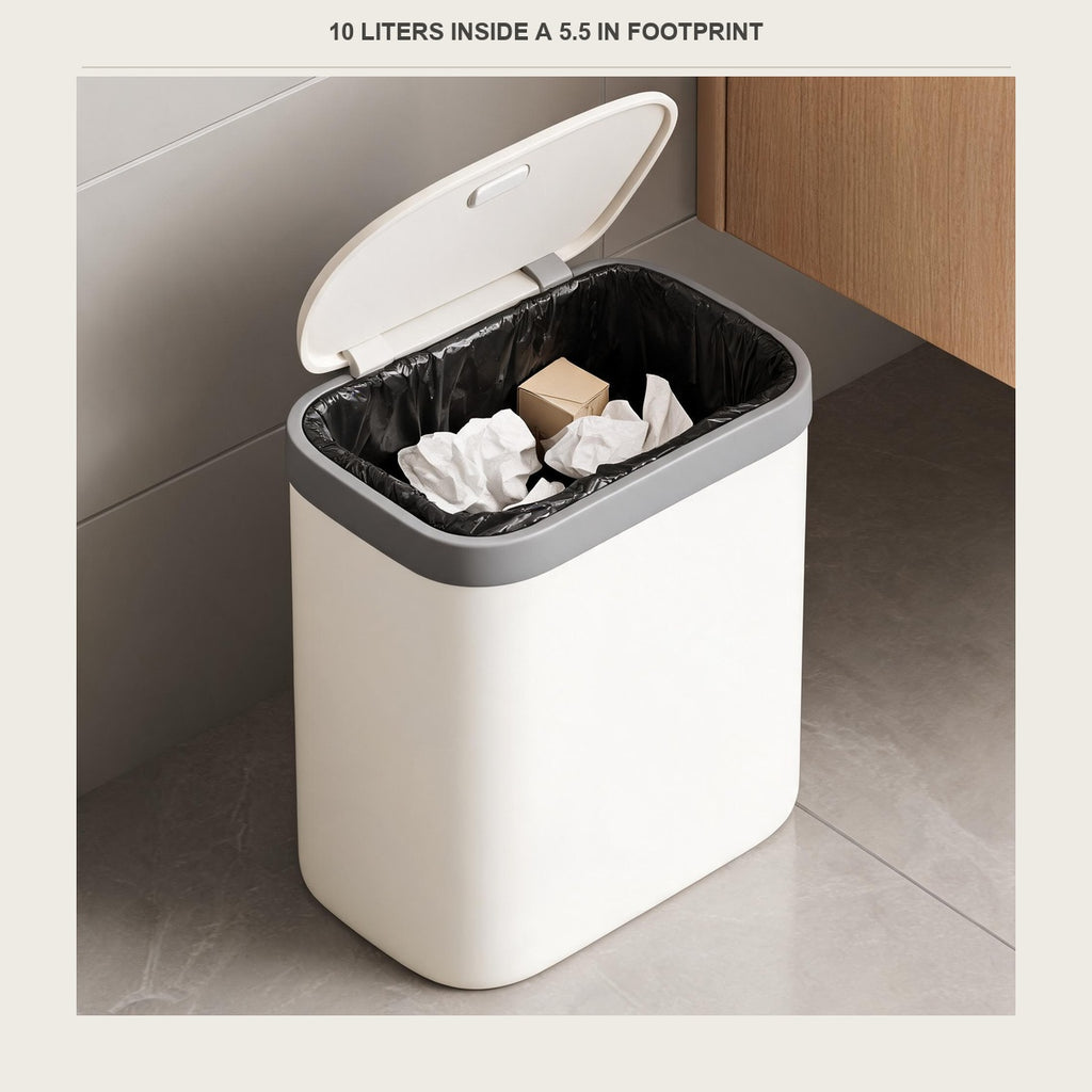 The bin with the lid open and a liner in place, holding a few bits of paper