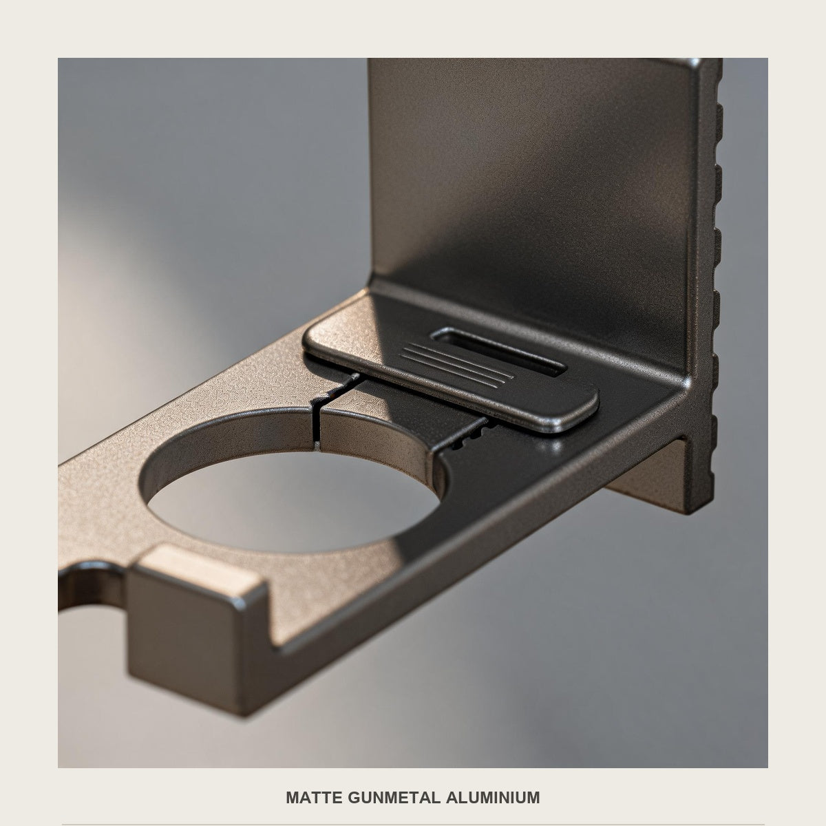 Macro of the matte gunmetal aluminium tray, the slot and the metal edge of the round opening