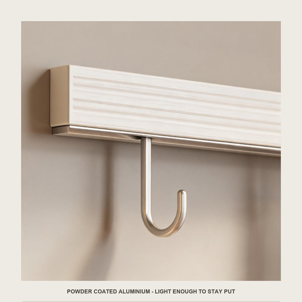 Macro of the powder coated off white bar and one champagne wire hook