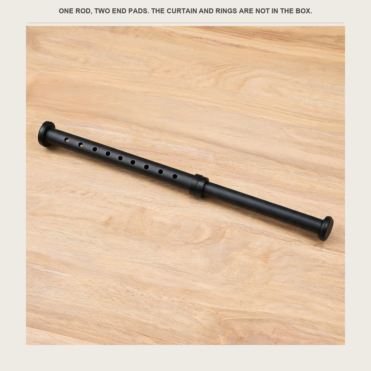 The tension rod lying on a pale wood counter with its end pads