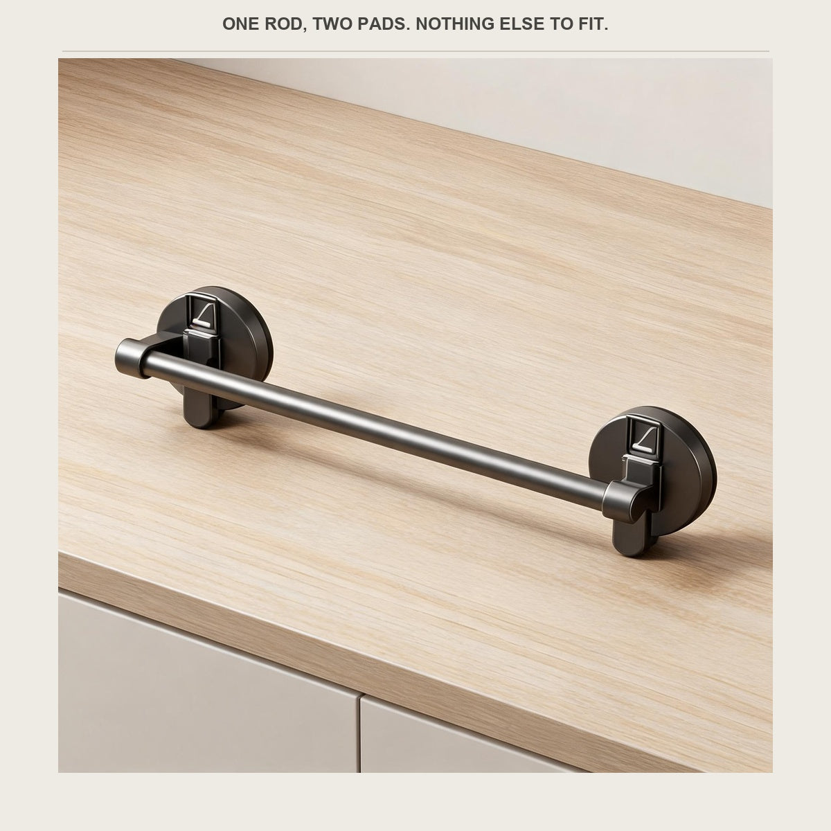 The bar with its two suction pads laid flat on a pale wood surface