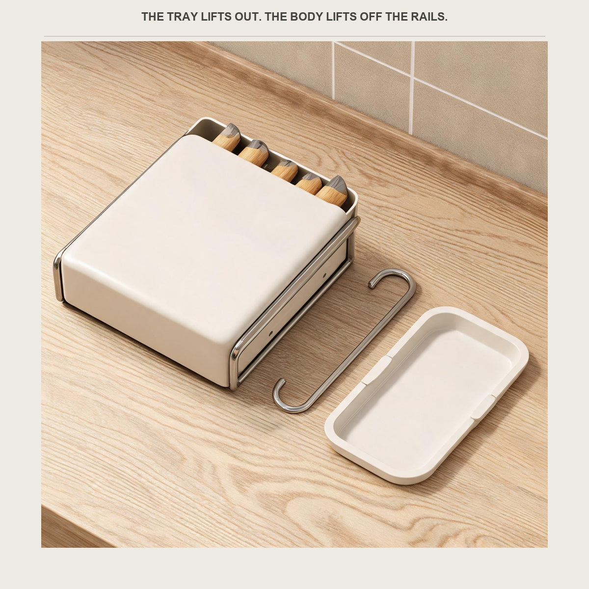 The utensil holder laid on a pale wood counter with the drip tray beside it