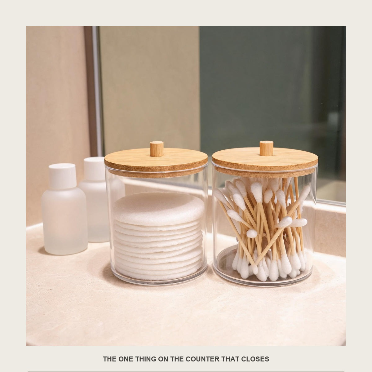 Two acrylic swab jars on a bathroom counter next to plain unbranded white bottles