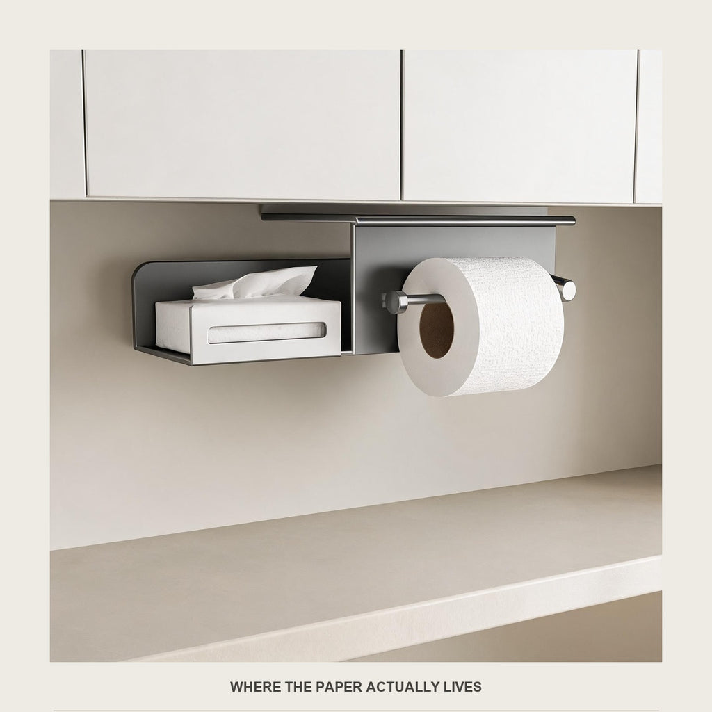 The paper holder under a bathroom mirror cabinet with a roll of paper on the bar