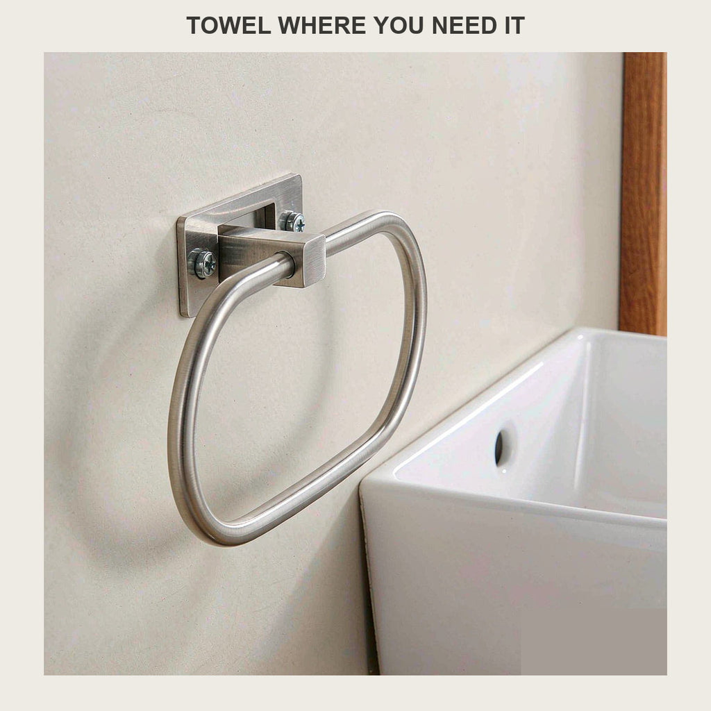 Brushed steel towel ring on a beige bathroom wall above a white sink
