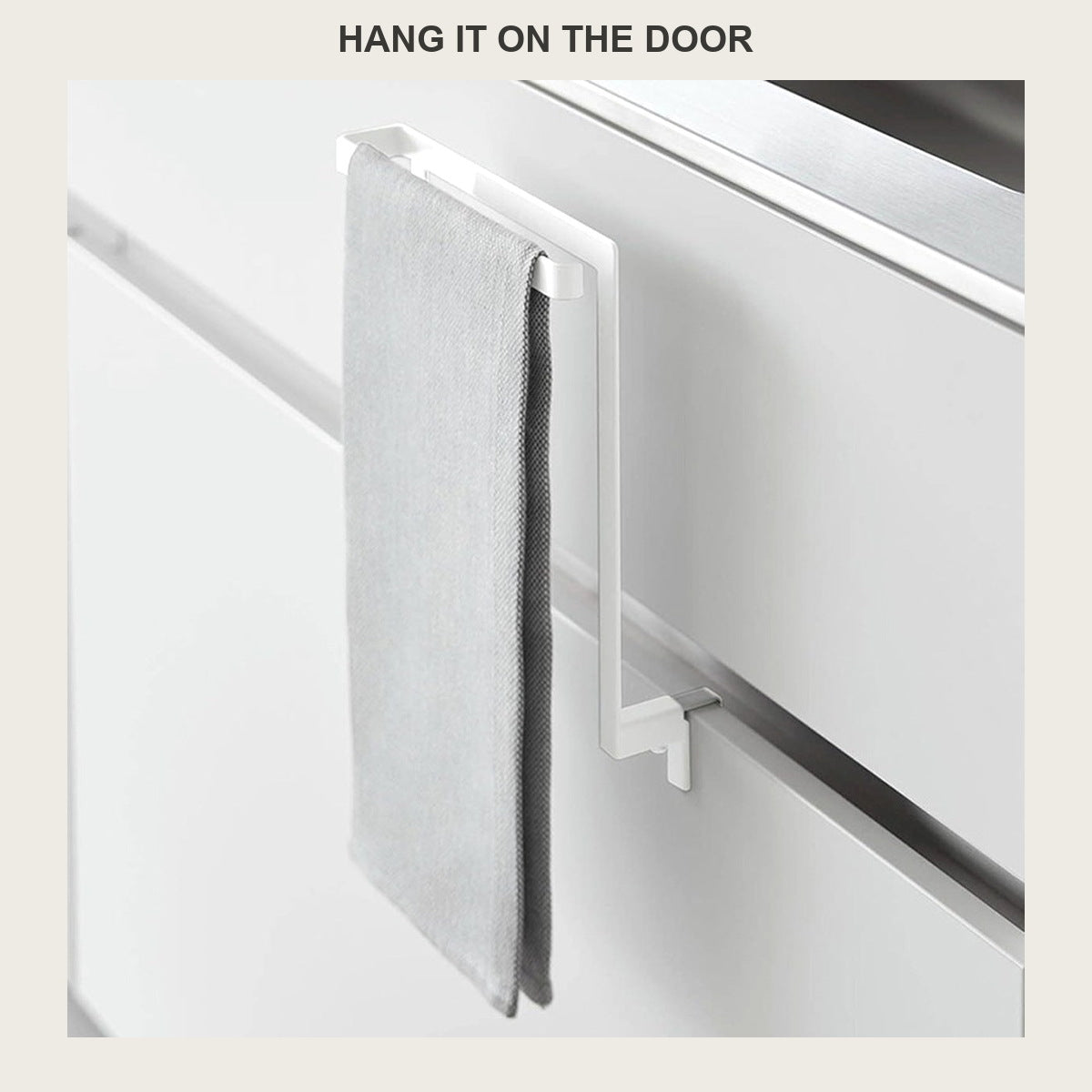 Grey towel hanging on the no-drill rack clamped over a white cabinet door