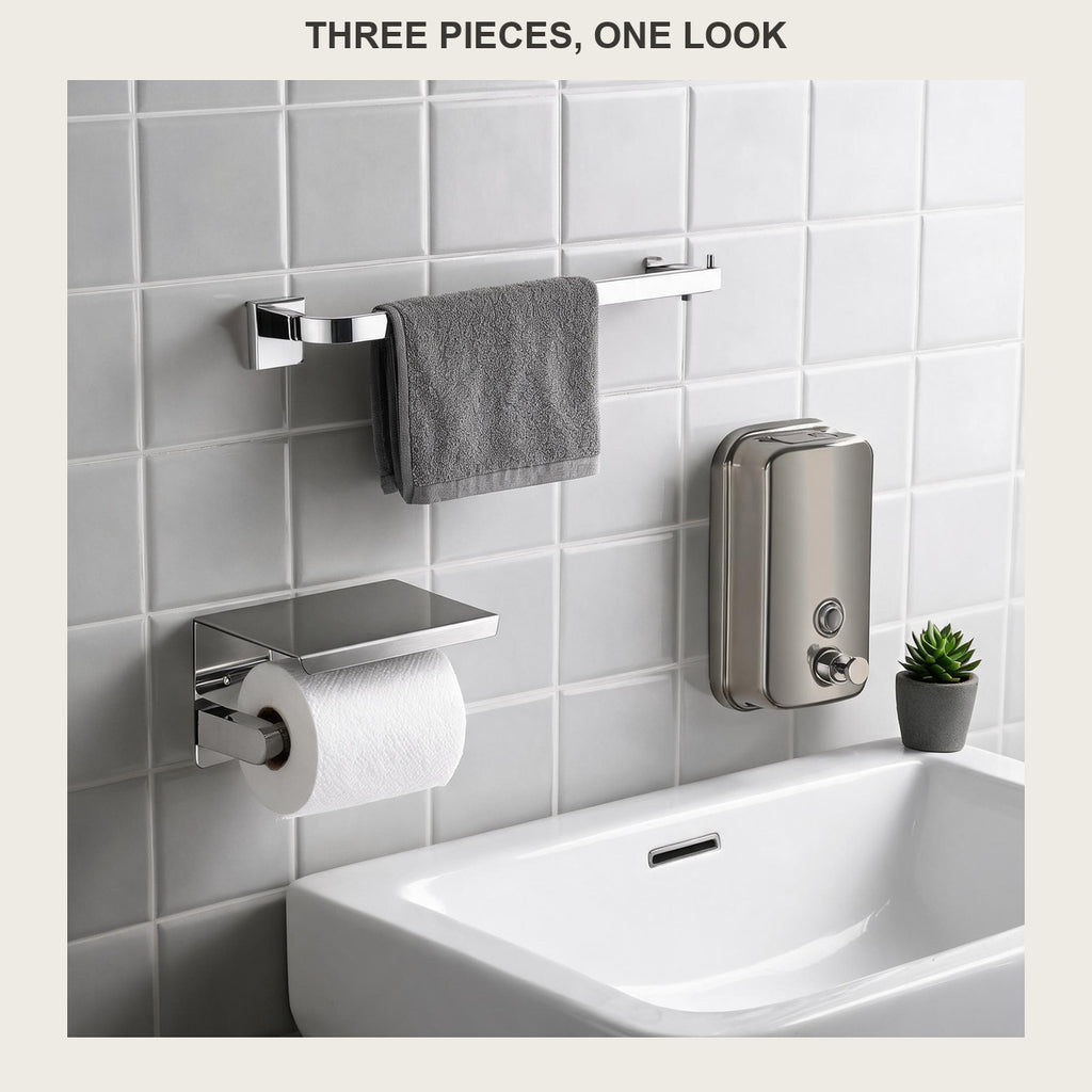 Three-piece brushed stainless bathroom set on a tiled wall: towel bar, paper holder and soap dispenser