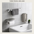 Three-piece brushed stainless bathroom set on a tiled wall: towel bar, paper holder and soap dispenser