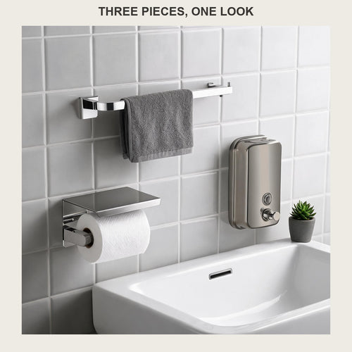 Three-piece brushed stainless bathroom set on a tiled wall: towel bar, paper holder and soap dispenser