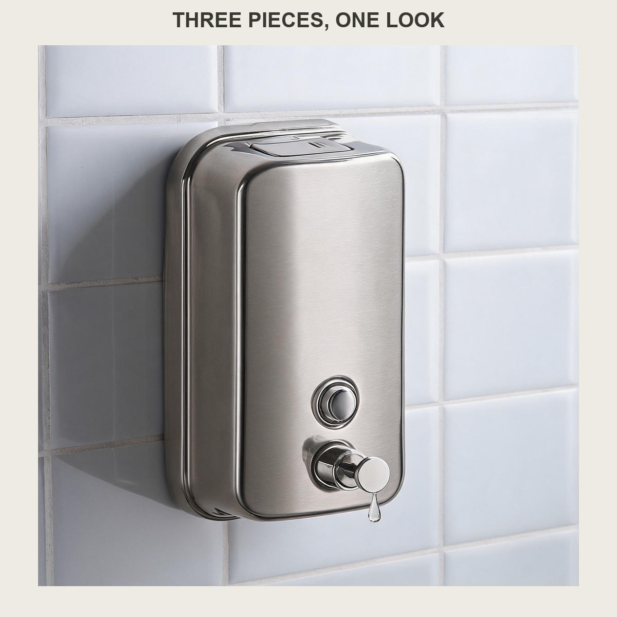 Close-up of the wall-mounted brushed steel soap dispenser with soap leaving the pump