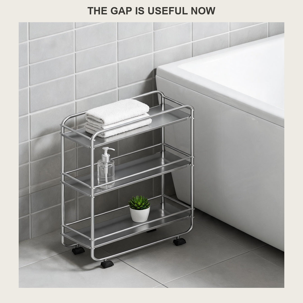 Slim three-tier rolling cart beside a white bathtub holding towels and a bottle of body wash