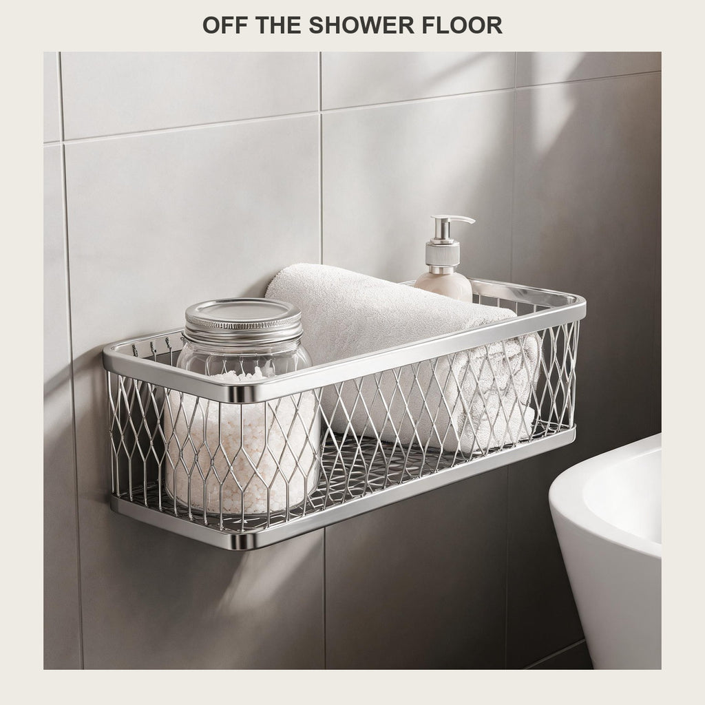 Rectangular stainless steel shower caddy on a grey tiled wall beside a freestanding bathtub