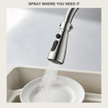 Hand holding the chrome 3-mode faucet sprayer head, showing its 720-degree rotation