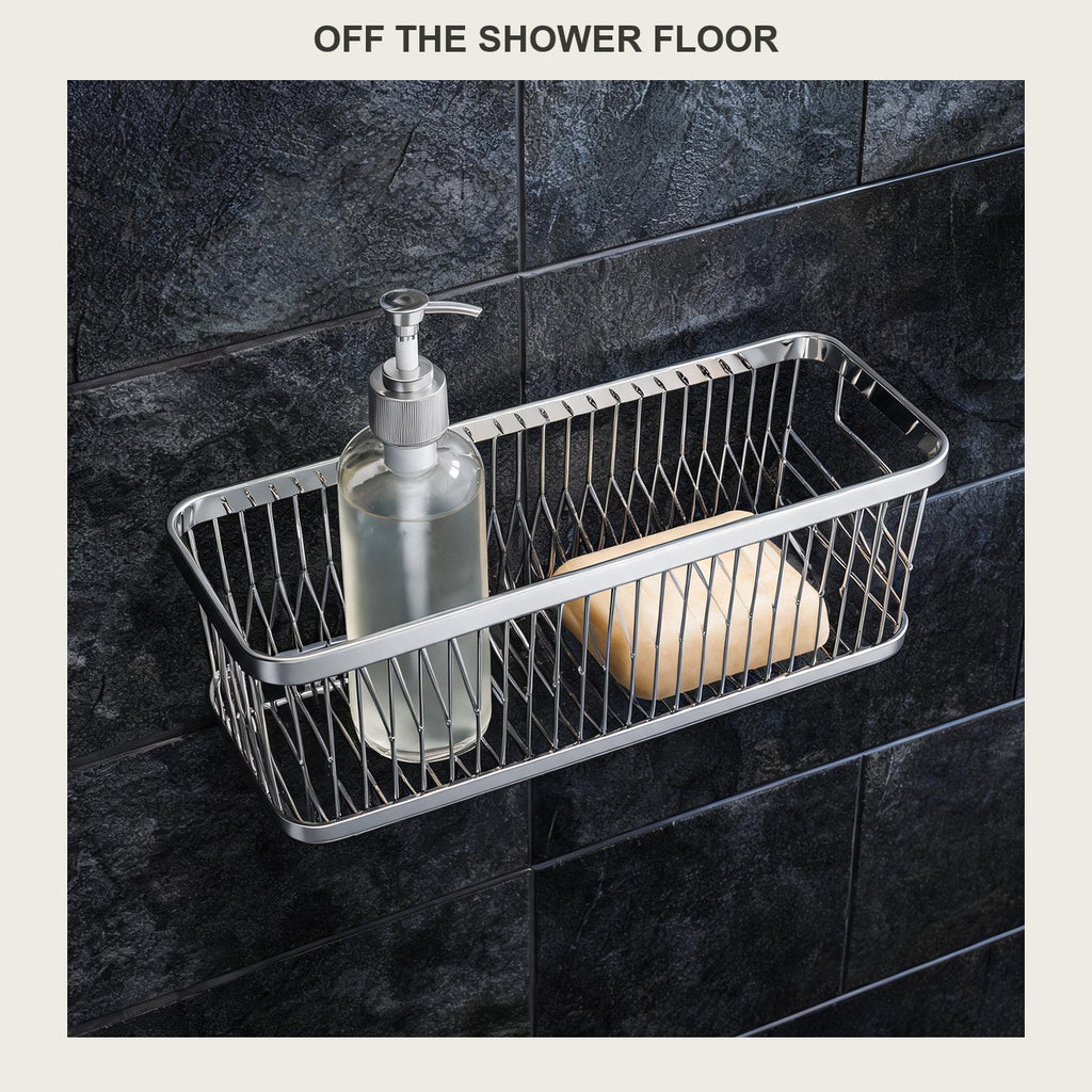 Rectangular stainless steel shower caddy on a dark slate shower wall holding a shampoo bottle